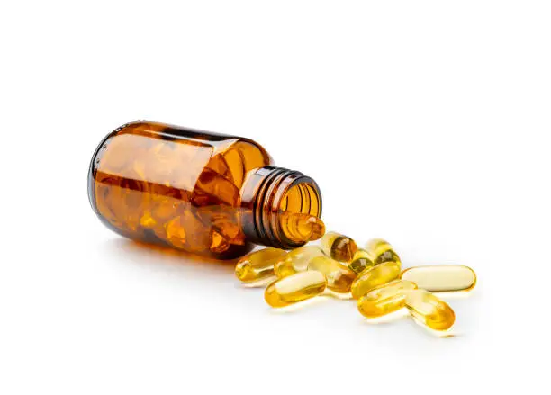 Fish oil capsules or salmon next to dog food omega 3 fatty acids for dog skin health